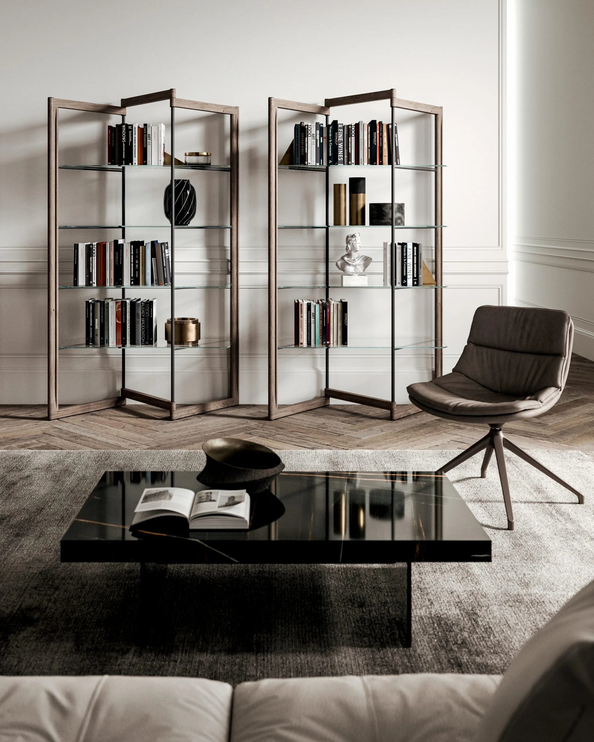 Two wooden-framed glass bookhelves filled with books and decorative objects in a light-filled living room, with a glossy black coffee table in the foreground.